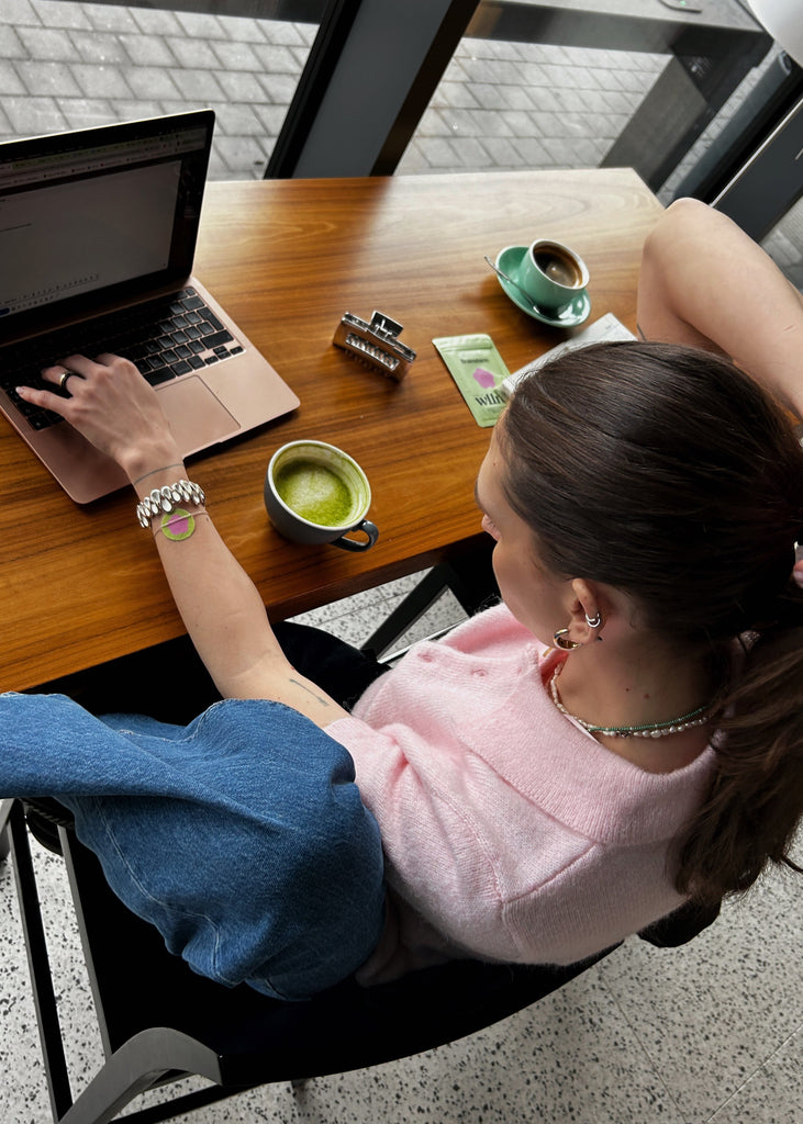 woman working on her laptop in a coffee shop