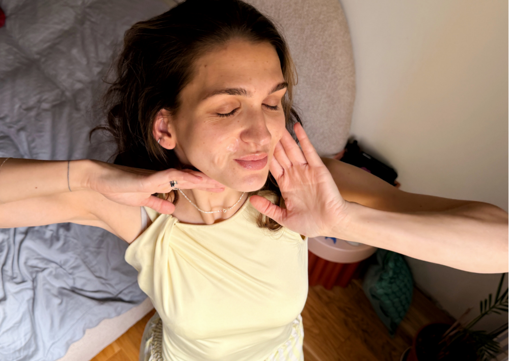 girl with headphones drinking water, wearing heart-shaped microneedle spot patches