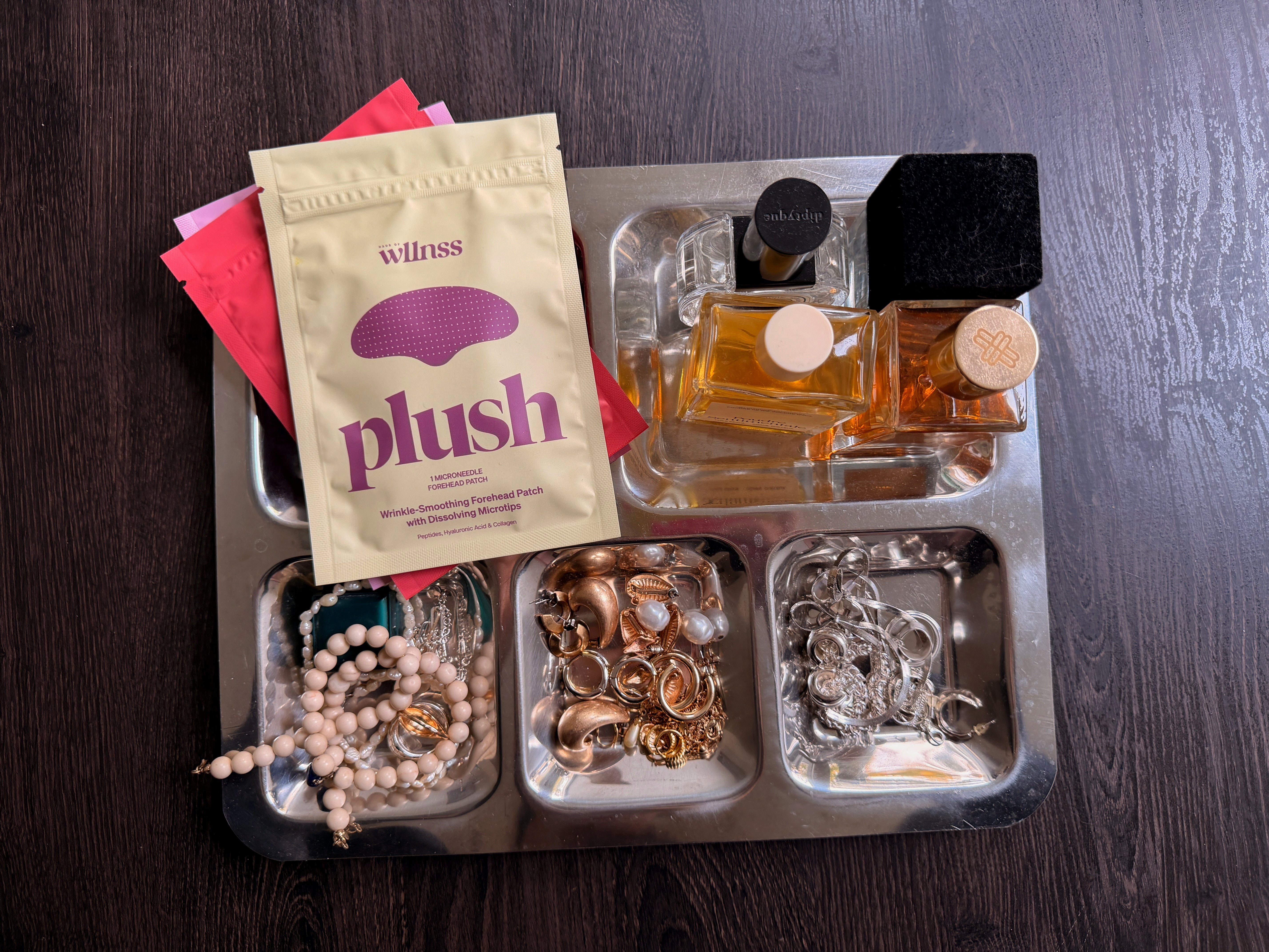 girl with headphones drinking water, wearing heart-shaped microneedle spot patches